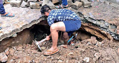 A man repairs a portion of road in Mansarovar on Sunday