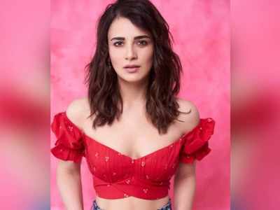 Radhika Madan takes on the '90s-inspired navel-baring cowl dress, offering  us sexy NYE inspiration