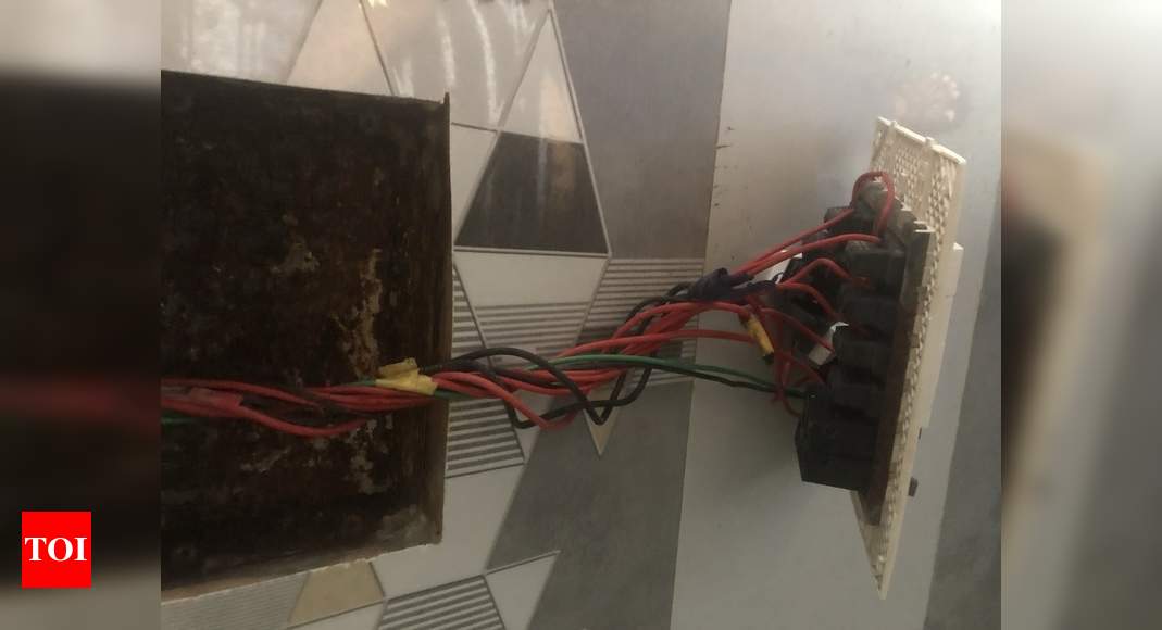 electrical switch board hanging in the toilet - Times of India