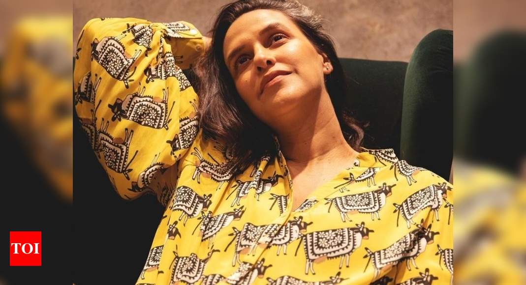 Pregnant Neha Dhupia is comfy in a designer printed yellow shirt worth