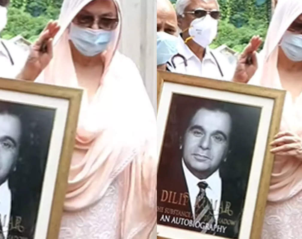 
Saira Banu holds her late husband Dilip Kumar's framed picture and waves at paparazzi in her first public appearance since the actor's death

