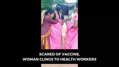 Watch: Healthcare workers have to hold woman down to administer Covid-19 vaccine