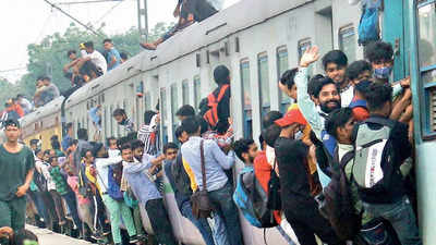 Commuters risk life to board local train through half-open doors