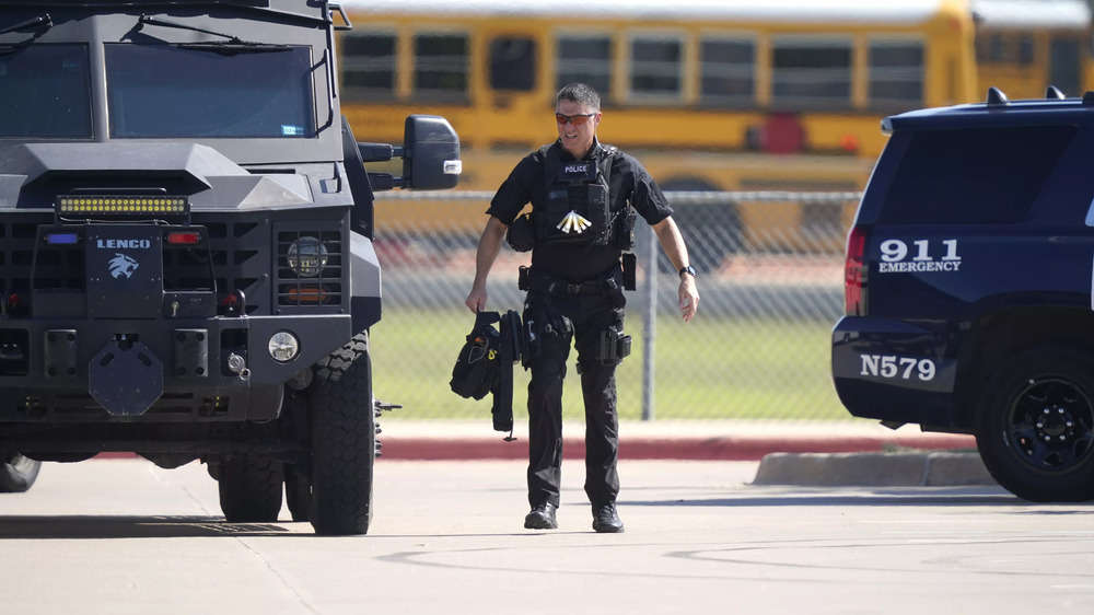 A law enforcement officer in the parking lot of Timberview High School after the shooting inside.