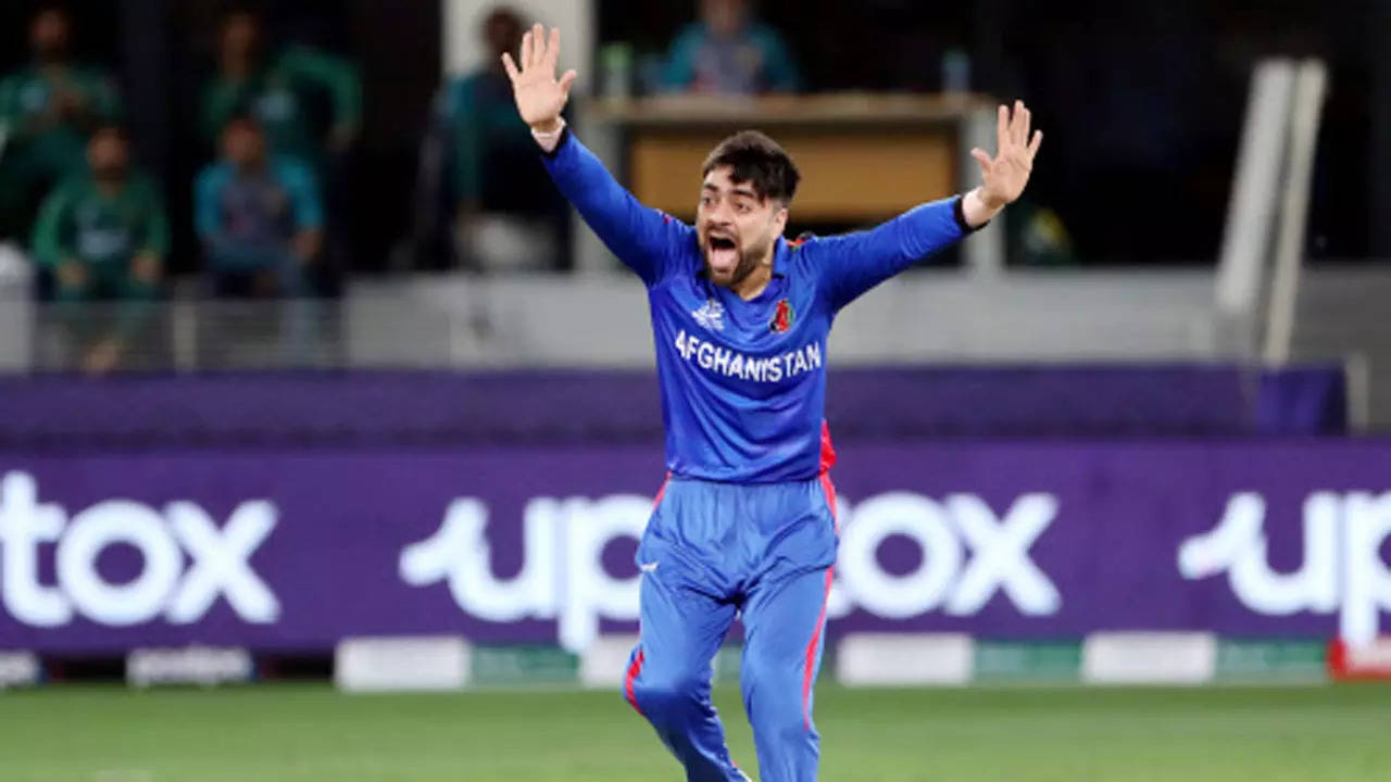 Afghanistan spinner Rashid Khan becomes fastest player to reach 100 T20I  wickets | Cricket News - Times of India