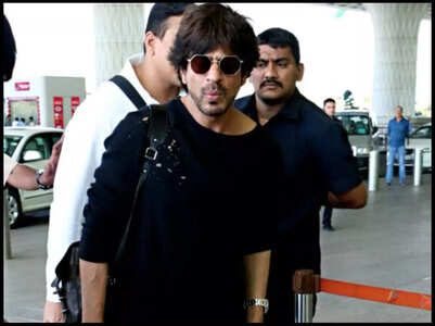 Watch: SRK hides under umbrella on arrival in city