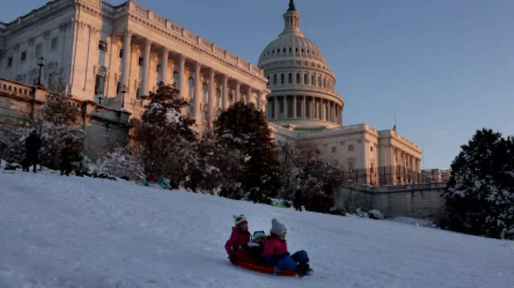 ​People go sledding on the West Front of the US Capitol Building on January 04