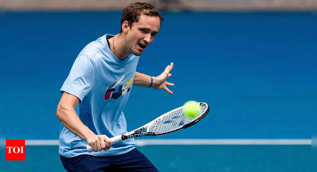 Daniil Medvedev of Russia, right, poses after winning the final