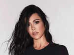 Kourtney Kardashian turns heads in a strappy black swimsuit in these stunning pictures from her romantic getaway