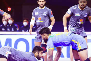 U.P. Yoddha's players pin down Telugu Titan's player, in black jersey,  during their Vivo Pro Kabaddi League match in Ahmadabad, India, Saturday,  Aug. 12, 2017. (AP Photo/Ajit Solanki Stock Photo - Alamy