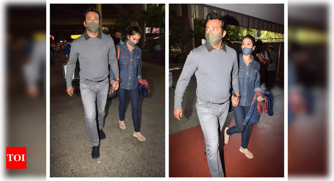 Kim Sharma and Leander Paes walk hand-in-hand as they get clicked at the airport – See pics – Times of India