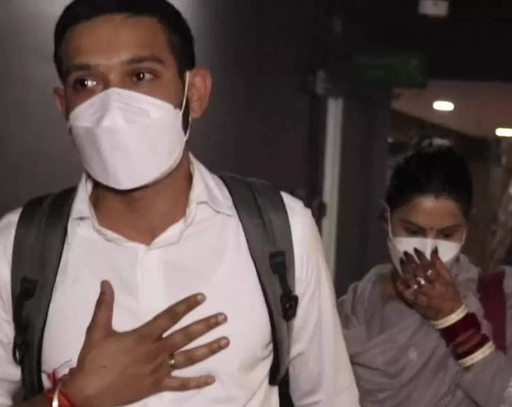 
Newlyweds Vikarnt Massey and Sheetal Thakur walk hand-in-hand at the airport
