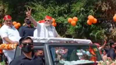 PM Modi shows 'V' sign during Ahmedabad roadshow | India News