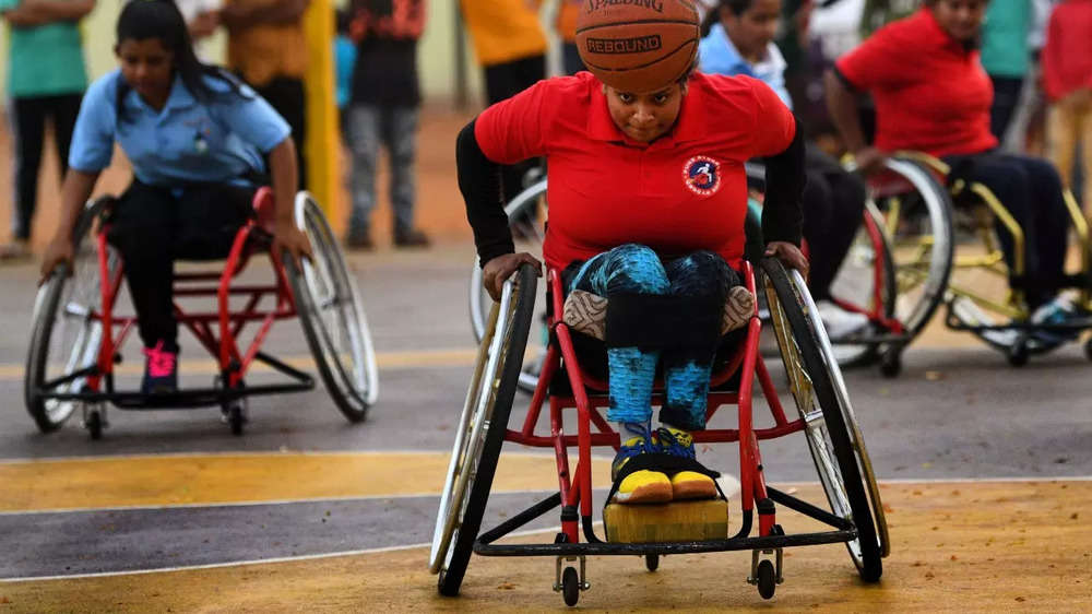 Wheelchair-bound sportspersons play basketball.