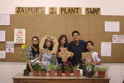 Gardening enthusiasts exchange plants at a swap event and learn about gardening tips