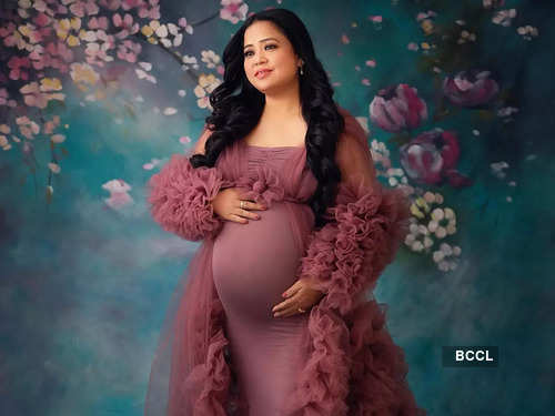 A pregnant Indian lady poses for indoor pregnancy shoot and hands