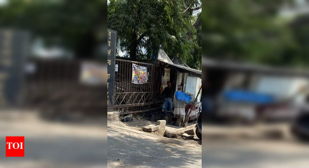 Footpath being encroached - Times of India