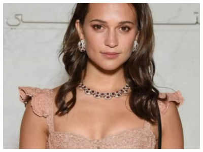 Alicia Vikander is every inch the doting mum as she enjoys a day