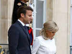 Emmanuel Macron and his wife Brigitte Macron walk down the stairs to receive PM Modi.