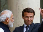 Emmanuel Macron gives a thumbs up as he welcomes PM Modi