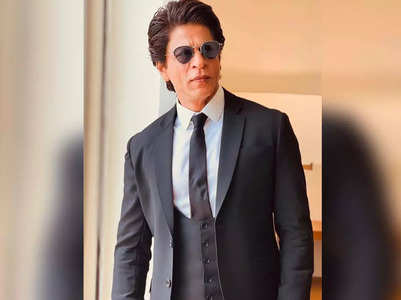 SRK dons dapper black suit for Delhi visit