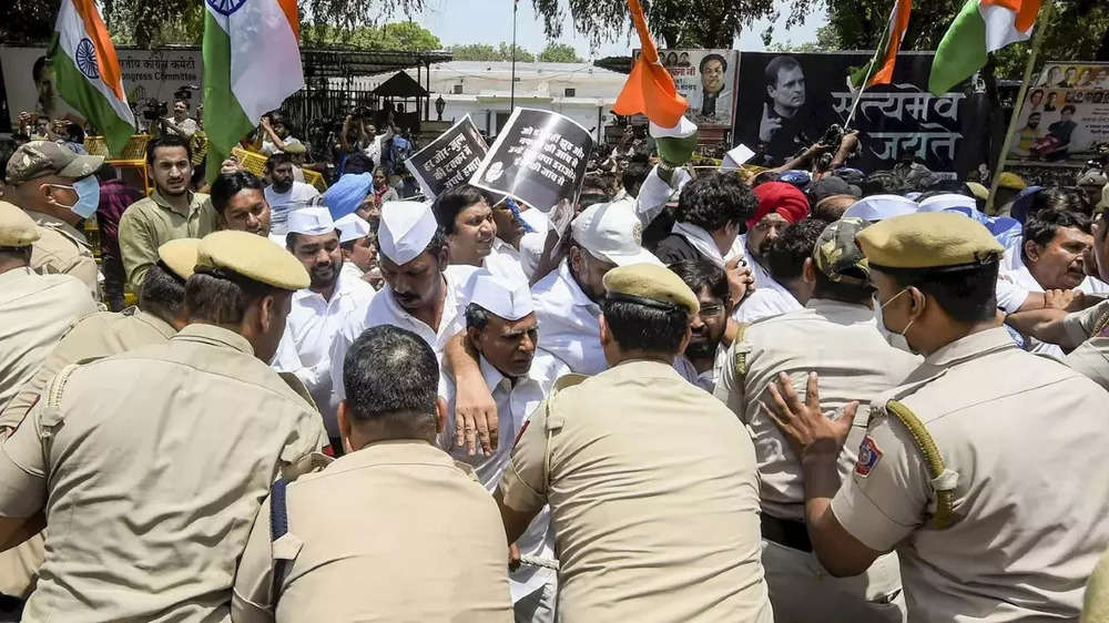 Police stop Congress workers during a protest outside the AICC office against summoning of party leader Rahul Gandhi by the ED, in New Delhi.