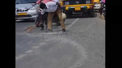 Watch: Traffic cop sweeps stones off busy road to ensure vehicle don’t slip, gets hailed