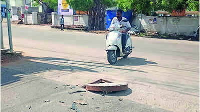 Protruding manhole lids pose threat to motorists