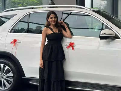 Nikki Tamboli poses with her new luxury car