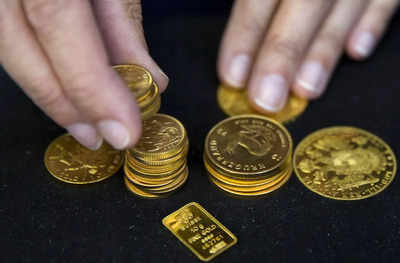 Gold drops to near one-year low as rate-hike fears loom