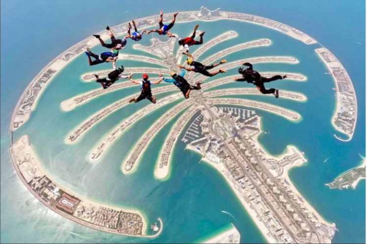 Skydiving or a gyrocopter flight over the city