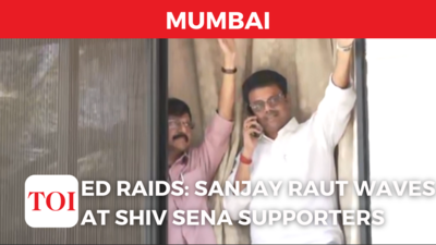 Sanjay Raut waves at Shiv Sena supporters as ED raids his residence in Mumbai