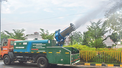 A truck-mounted anti-smog gun sprinkles water on a road in Patna.