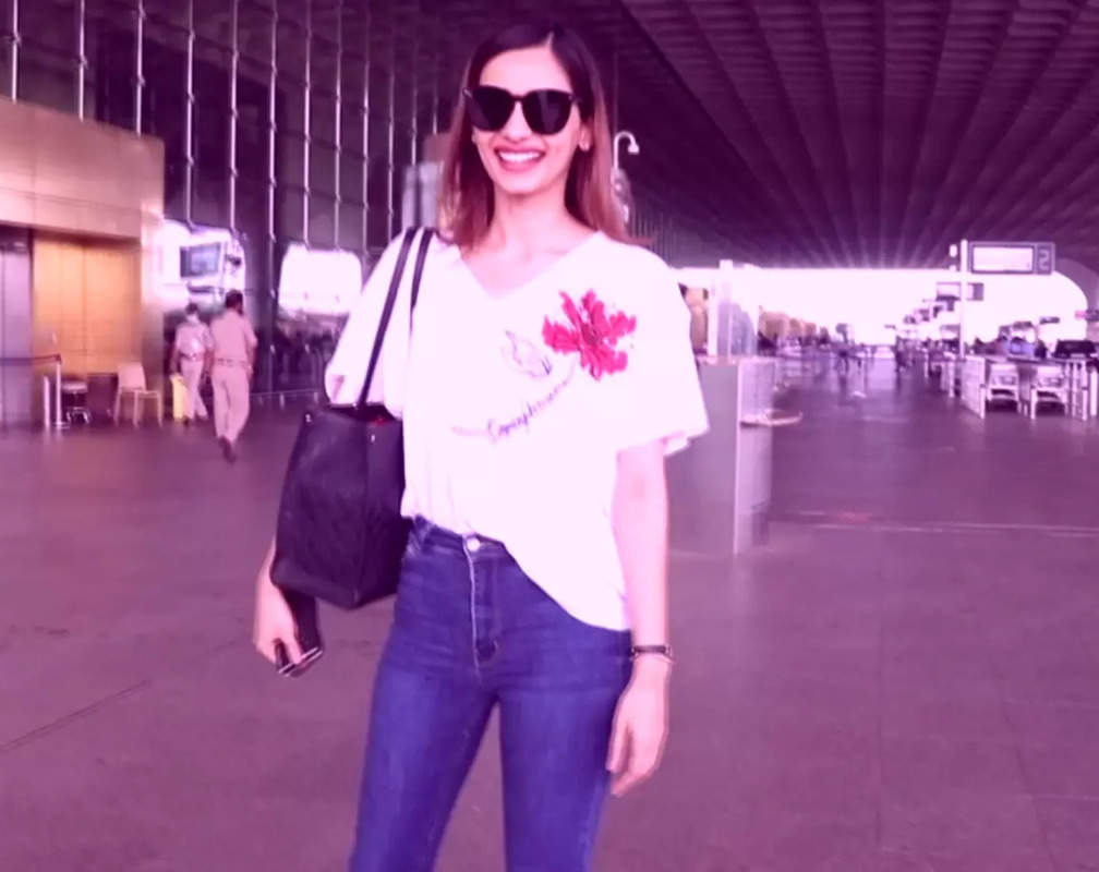 
Manushi Chhillar dons an oversized white tee and bell bottom jeans, completes her look with black sunglasses
