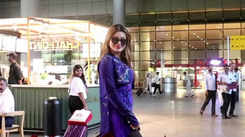 Urvashi Rautela dons a purple designer dress paired with black pants, completes her look with black sunglasses