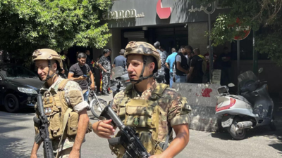 Armed man demanding savings takes Beirut bank staff hostage; many hail him as hero