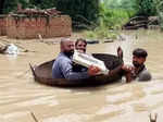 Pakistan : Residents cross a flooded area in a makeshift boat amid floods caused by heavy downpours. (Photo: -/PPI via ZUMA Press Wire/dpa/IANS)