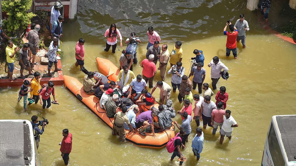 Fire fighters evacuate residents from flooded areas in Bengaluru. (Photo: PTI)