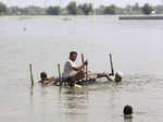 People use cot to salvage belongings from their nearby flooded home caused by he...