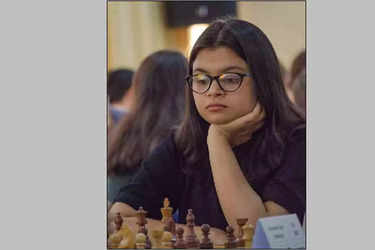 V. P. Kaushik, 11, watches as Indian World Rapid Chess Champion Viswanathan  Anand, unseen right, makes a move at the launch of a school chess  tournament organized by the NIIT Mind Champion's