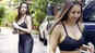 Malaika dons a hot black sports bra with matching yoga pants