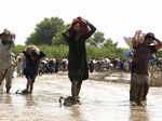 Victims of unprecedented flooding from monsoon rains receive relief aid organize...