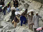 Kalam Local residents cross a portion of road destroyed by floodwaters in Kalam ...