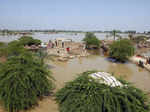 Homes are surrounded by floodwaters in the Shikarpur district of Sindh Province,...