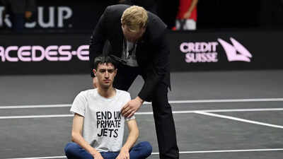 Laver Cup match briefly halted after protester sets arm on fire on court