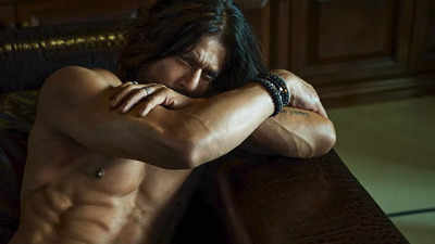 Shah Rukh Khan shares shirtless picture flaunting his toned abs and long locks: 'Tum hoti toh kaisa hota….'