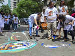 Mumbai: Members of WatchDog Foundation paint potholes to protest over the condit...