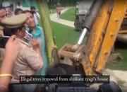 Anu tyagi stands in front of bulldozer to stop demolition of trees in Noida society