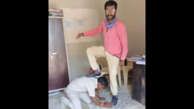MP revenue officer puts his foot on panchayat member's back; suspended