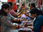 Amritsar: Women get henna applied on their hands on the eve of 'Karwa Chauth' in Amritsar, Wednesday, Oct. 12, 2022. (Photo:Pawan sharma/IANS)